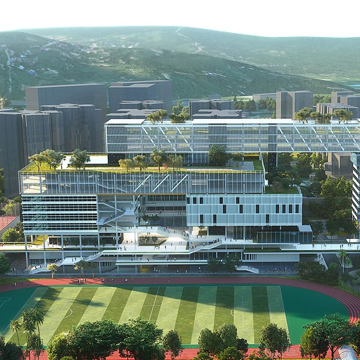 Aedas’ Shenzhen Airport Training Base with elevated office bars, campus courtyards and integrated athletics field. Aerial perspective of Aedas’ Shenzhen Airport Training Base showing horizontally layered office and training buildings connected by elevated corridors. The complex frames a regulation football field with a 400‑metre running track at ground level. Glazed façades, roof gardens and open courtyards integrate work, training and public leisure functions adjacent to airport infrastructure.