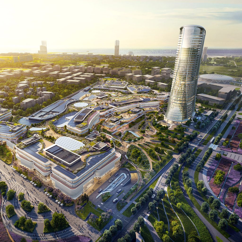 Aedas’ Ellinikon Commercial Hub in Athens with large-scale retail podiums, outdoor streetscapes and adjacent mixed-use tower. Aerial perspective of Aedas’ Ellinikon Commercial Hub showing expansive retail and leisure podiums with curvilinear roofs, outdoor pedestrian streets and landscaped terraces. A slender mixed-use tower rises alongside the mall complex. The development fronts Vouliagmenis Avenue and integrates shaded external circulation responding to the Mediterranean climate.