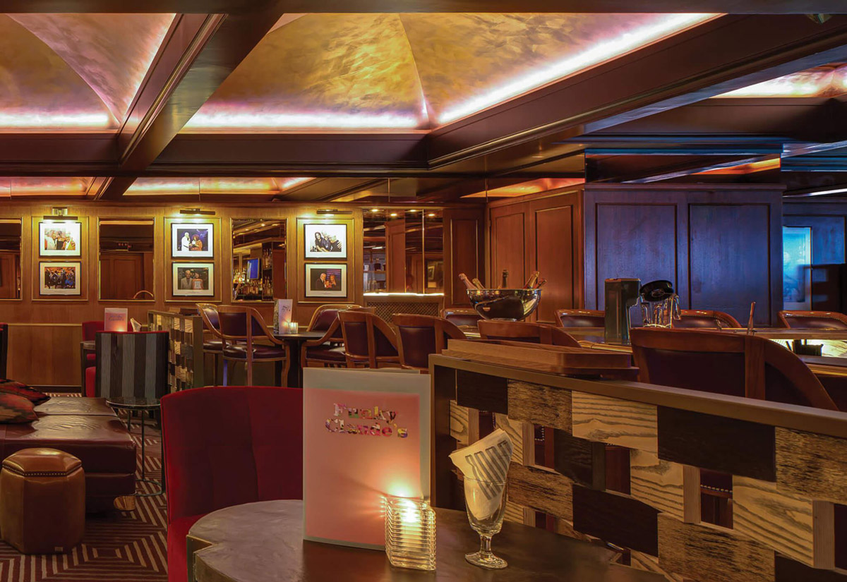 Aedas Interiors’ Montreux Jazz Café at Fairmont Le Montreux Palace is shown as a richly layered hospitality interior with warm timber walls, mirrored surfaces, curated music memorabilia, and intimate lounge seating. The image highlights a narrative‑driven dining environment inspired by jazz culture, using refined lighting, eclectic furnishings, and artisanal detailing to evoke the legacy and atmosphere of the Montreux Jazz Festival.