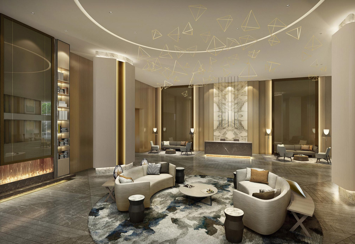 Aedas Interiors’ MIG Colony Residential Project in Mumbai is shown as an elegant residential lobby with curved upholstered seating, a sculptural feature chandelier composed of delicate geometric forms, and warm timber‑lined walls. The image highlights a contemporary living environment defined by soft neutral tones, layered lighting, polished stone flooring, and refined lounge configurations that create a calm, aspirational communal arrival space within a high‑density residential development.