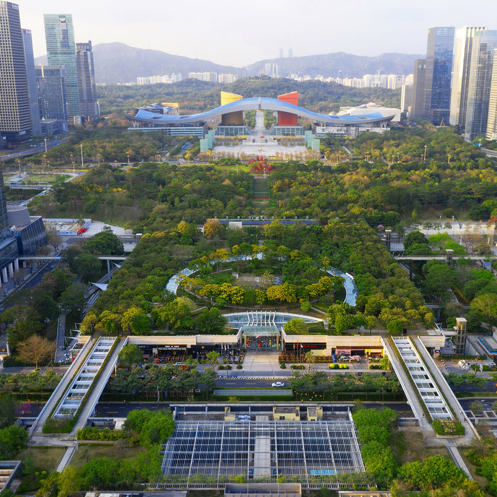 Aedas’s Link CentralWalk in Shenzhen is shown as a large‑scale urban development structured around a central linear park, terraced retail roofs, and underground commercial volumes. The aerial view highlights integrated landscape infrastructure, pedestrian‑first planning, and seamless connection between open space and surrounding high‑rise commercial towers.