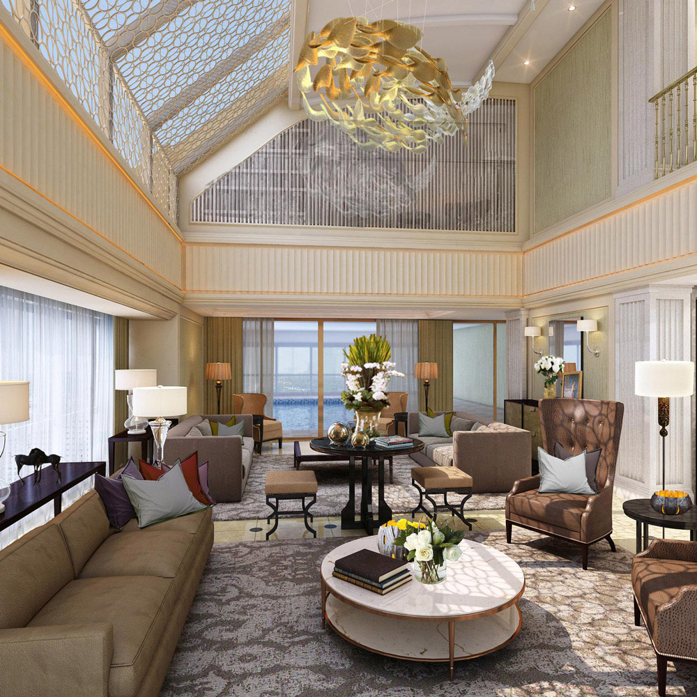 Aedas Interiors’ EPI Residences Monte Carlo Penthouse in Shenzhen is shown as a luxurious double‑height living space with layered upholstered seating, classical wall mouldings, a bespoke sculptural gold chandelier, and a mezzanine balustrade overlooking the lounge. The image highlights an opulent residential interior blending European elegance, refined symmetry, rich textiles, and warm lighting to create a grand yet inviting penthouse environment.