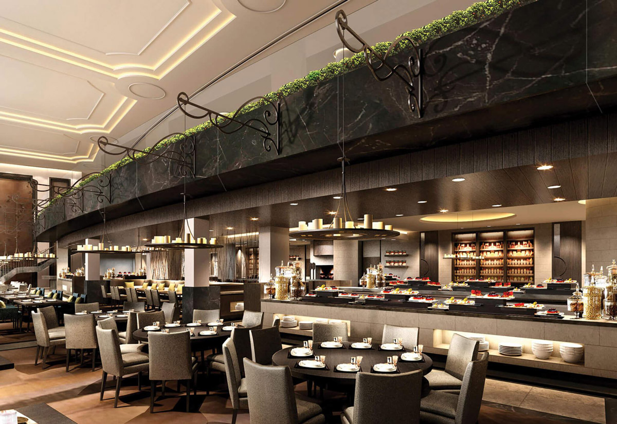 Aedas Interiors’ All-day Dining Restaurant in Wuhan is shown as an elegant, open dining space with a long buffet counter, marble finishes, and layered seating arrangements beneath delicate chandelier lighting. The image highlights a contemporary hospitality interior where soft illumination, refined materials, and balanced proportions create a warm, graceful atmosphere suitable for continuous daytime dining.