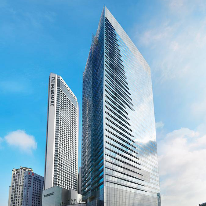 Aedas’ The Intermark in Kuala Lumpur is shown as a prominent mixed‑use podium with expansive curtain‑wall glazing, clearly articulated retail frontages, and upper towers rising above. The image highlights a refreshed urban complex combining office, hotel, and retail functions, where transparent façades, active street edges, and contemporary massing create a cohesive commercial and hospitality destination within the city core.