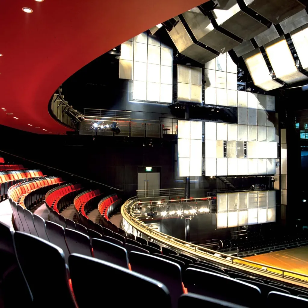 Aedas’s Sadler’s Wells Theatre in London is shown as a contemporary performance architecture defined by a curved auditorium geometry, tiered seating structure, and suspended acoustic panel system. The image highlights performance‑led building volume, integrated technical architecture, and controlled enclosure suited to large‑scale dance and theatre production.