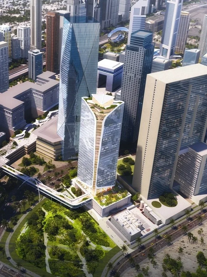 Aedas’ Immersive Tower by DIFC in Dubai is shown within the wider financial district as a sculptural mixed‑use landmark defined by twin V‑cut forms and vertical fin façades. The aerial view highlights stepped sky terraces, a landscaped podium with communal spaces, and the tower’s integration into the DIFC skyline, reinforcing a people‑centric, innovation‑driven urban destination.