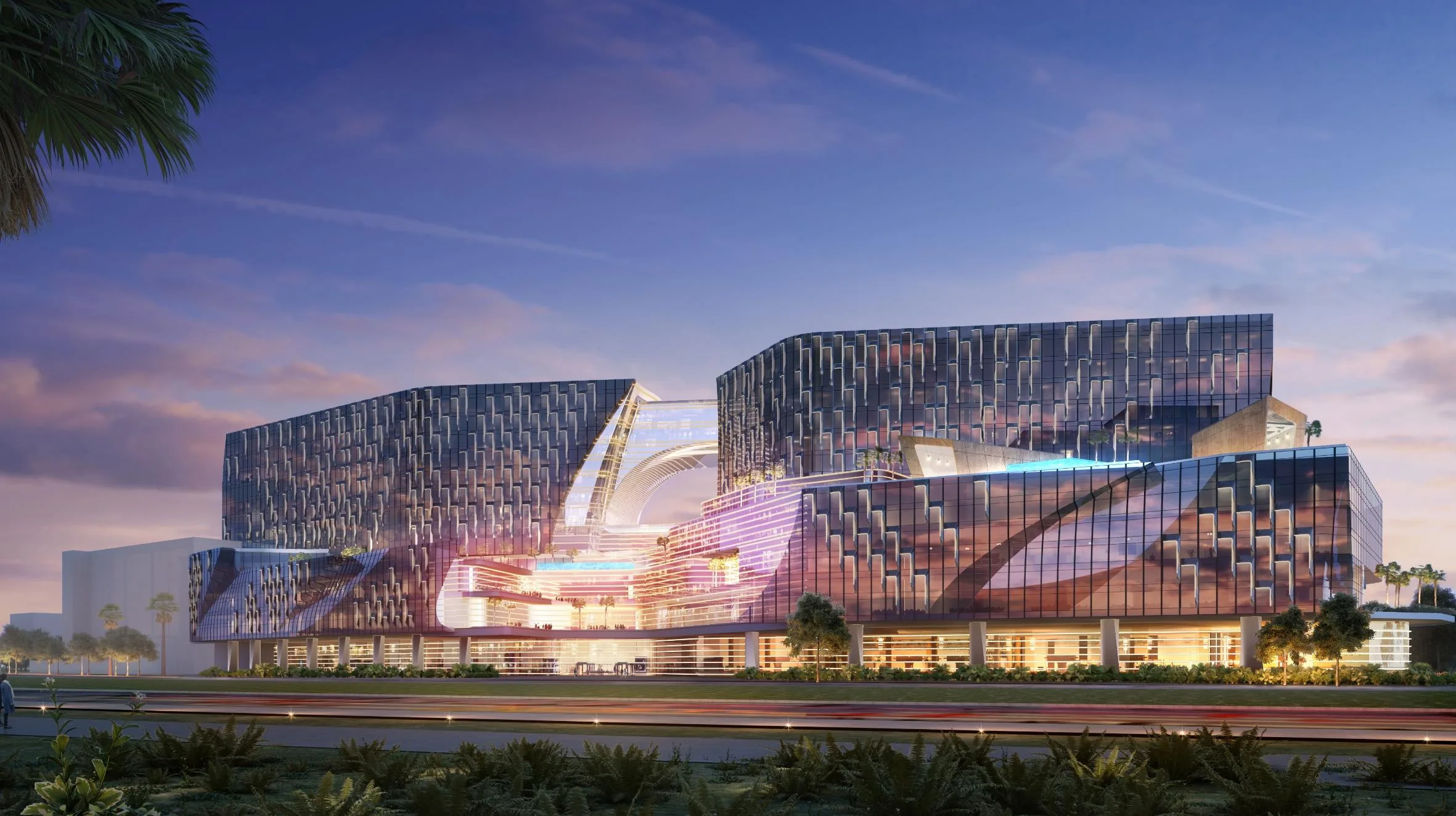 Aedas’s Westside City Integrated Resort in Manila is shown as a large‑scale resort complex with multiple sculpted building volumes, faceted glazed façades, and a continuous podium containing illuminated public spaces. The night‑time exterior highlights layered massing, expansive curtain walls, and destination‑scale hospitality architecture integrated within a landscaped coastal setting.